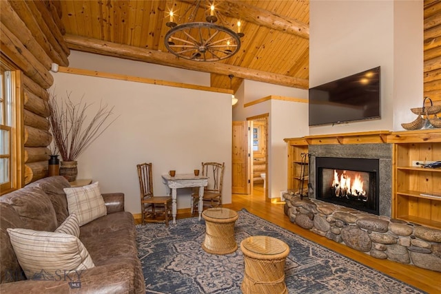 49824 Gallatin Rd, Big Sky, MT 59730 - living area with rustic walls, a wooden ceiling with exposed beams, a warm lit fireplace, wood finished floors, and high vaulted ceiling