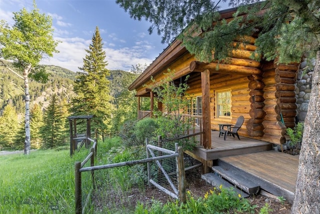 49824 Gallatin Rd, Big Sky, MT 59730 - view of yard with a deck and a view of trees
