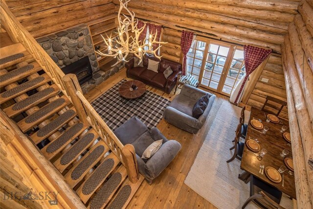 49824 Gallatin Rd, Big Sky, MT 59730 - living room with hardwood / wood-style flooring, log walls, and a fireplace