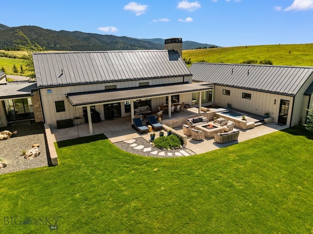 1878 Star Ridge Rd, Bozeman, MT 59715 - back of house with an outdoor living space with a fire pit, a patio, a chimney, and a lawn
