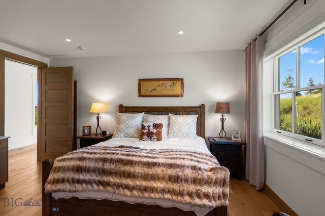 1878 Star Ridge Rd, Bozeman, MT 59715 - bedroom featuring multiple windows, light wood finished floors, and recessed lighting