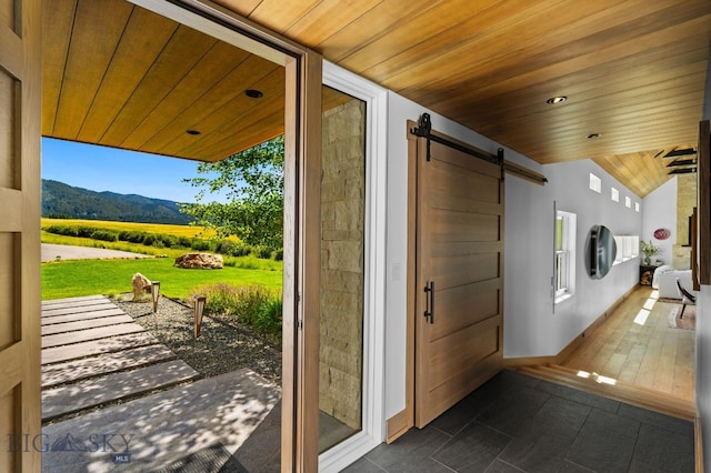 1878 Star Ridge Rd, Bozeman, MT 59715 - entryway with wooden ceiling, a barn door, lofted ceiling, a mountain view, and dark tile patterned flooring