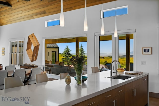 1878 Star Ridge Rd, Bozeman, MT 59715 - kitchen with open floor plan, a high ceiling, light countertops, modern cabinets, and dark wood finished floors