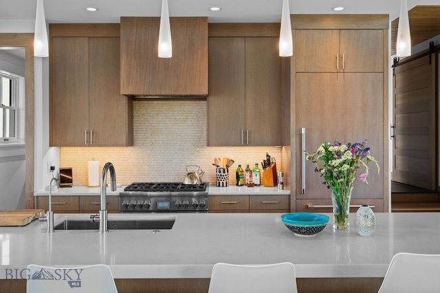 1878 Star Ridge Rd, Bozeman, MT 59715 - kitchen with stainless steel range with gas cooktop, light countertops, and backsplash