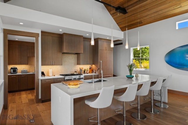 1878 Star Ridge Rd, Bozeman, MT 59715 - kitchen with wood-type flooring, a kitchen bar, light countertops, modern cabinets, and wood ceiling