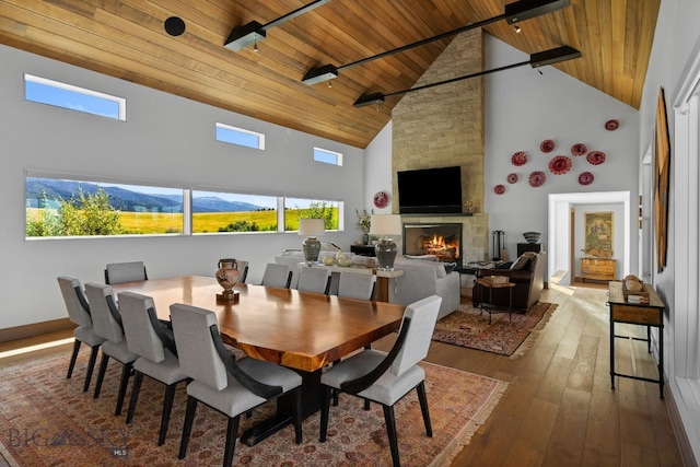 1878 Star Ridge Rd, Bozeman, MT 59715 - dining room featuring wooden ceiling, high vaulted ceiling, hardwood / wood-style floors, a fireplace, and healthy amount of natural light