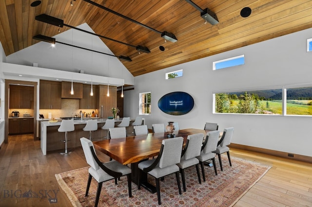 1878 Star Ridge Rd, Bozeman, MT 59715 - dining area with a wooden ceiling with exposed beams, high vaulted ceiling, light wood-style flooring, and healthy amount of natural light