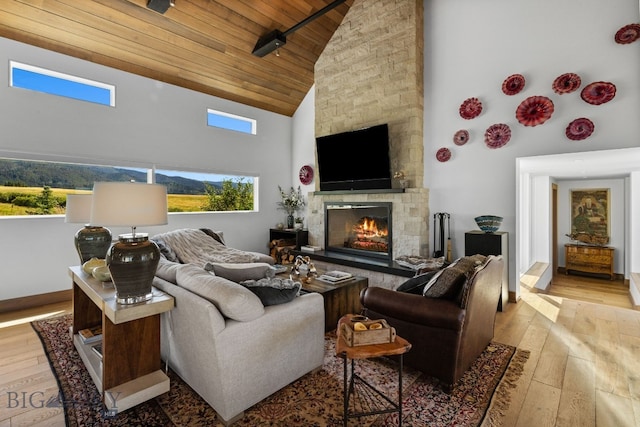 1878 Star Ridge Rd, Bozeman, MT 59715 - living area featuring high vaulted ceiling, wooden ceiling, wood-type flooring, and a stone fireplace