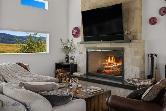 1878 Star Ridge Rd, Bozeman, MT 59715 - living room featuring a stone fireplace and a high ceiling