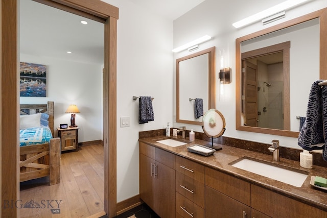 1878 Star Ridge Rd, Bozeman, MT 59715 - ensuite bathroom featuring double vanity, a tile shower, wood finished floors, and recessed lighting