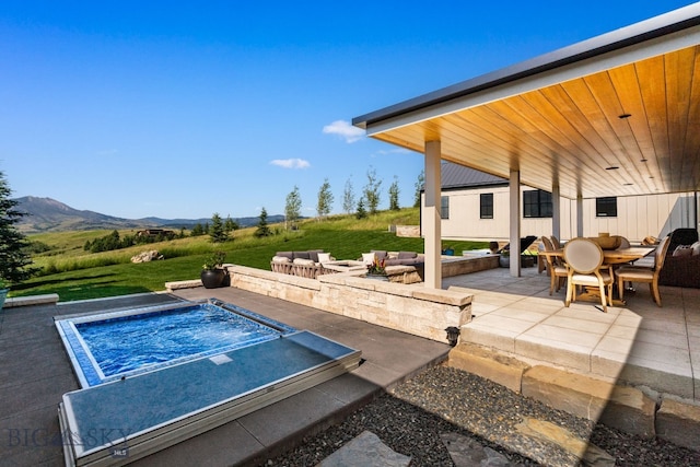 1878 Star Ridge Rd, Bozeman, MT 59715 - view of patio with a jacuzzi, a mountain view, and outdoor dining space