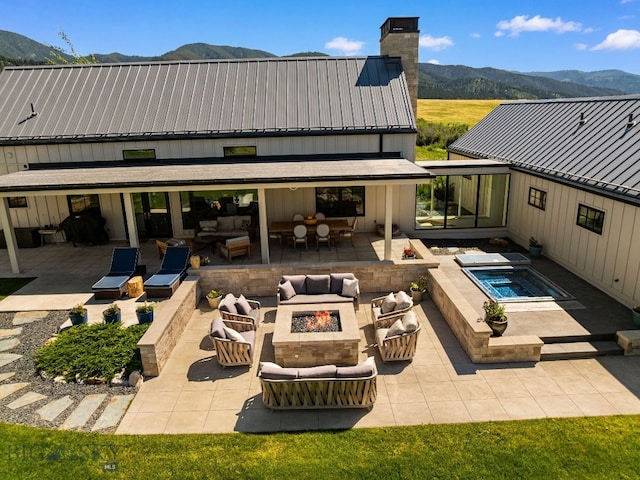 1878 Star Ridge Rd, Bozeman, MT 59715 - view of patio / terrace with an outdoor living space with a fire pit, a mountain view, and an in-ground hot tub