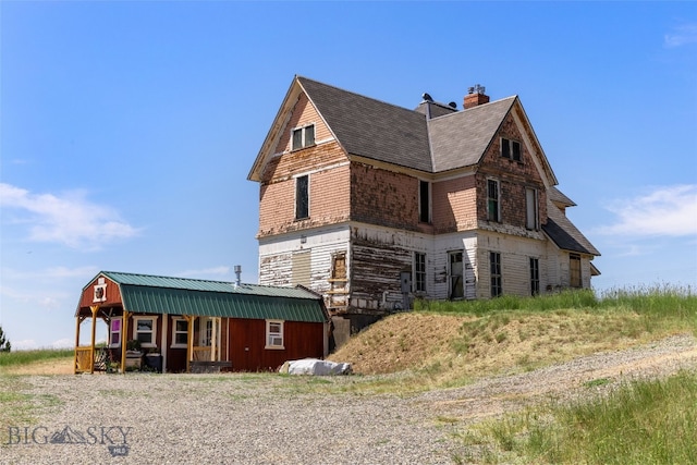 5835 Spaulding Bridge Rd, Belgrade, MT 59714 - view of property exterior with a porch and a chimney
