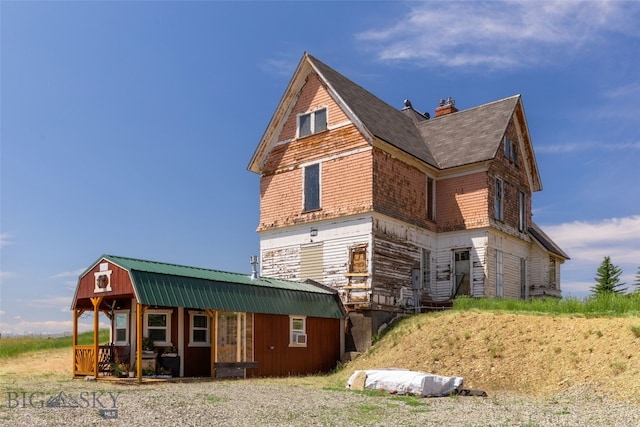 5835 Spaulding Bridge Rd, Belgrade, MT 59714 - view of home's exterior with a porch and a chimney