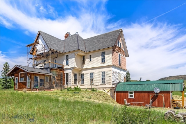 5835 Spaulding Bridge Rd, Belgrade, MT 59714 - view of side of home featuring a chimney and a shingled roof