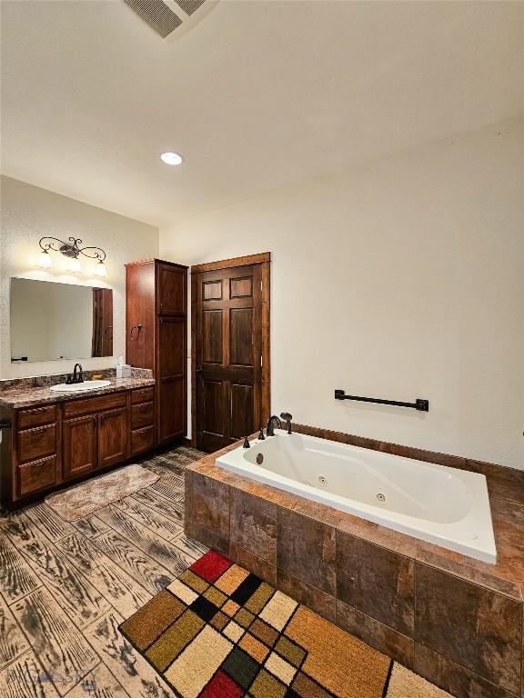 115 Otter Creek Rd, Big Timber, MT 59011 - bathroom featuring a tub with jets, vanity, and recessed lighting
