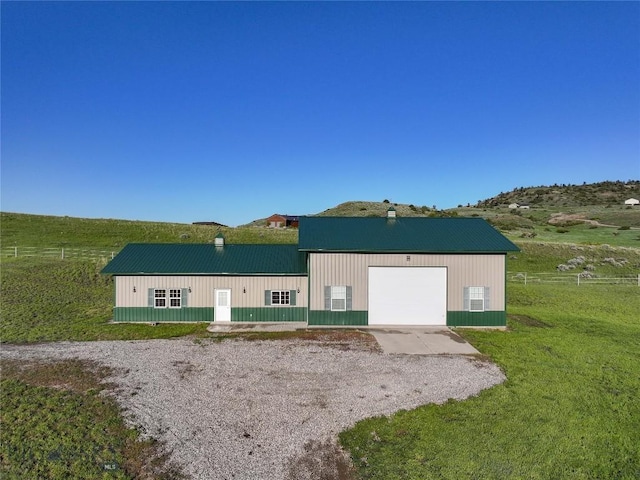115 Otter Creek Rd, Big Timber, MT 59011 - back of house with a chimney, a metal roof, gravel driveway, and a garage
