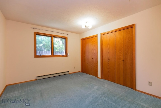 2200 W Dickerson Unit 46, Bozeman, MT 59718 - unfurnished bedroom featuring a baseboard radiator, two closets, and carpet flooring