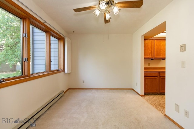 2200 W Dickerson Unit 46, Bozeman, MT 59718 - spare room featuring a baseboard radiator, light carpet, and a ceiling fan