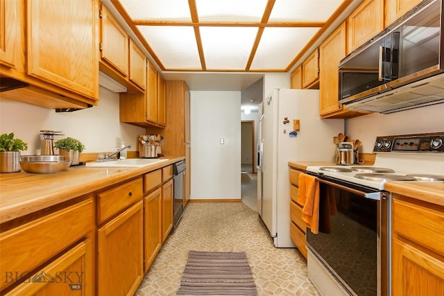 2200 W Dickerson Unit 46, Bozeman, MT 59718 - kitchen with appliances with stainless steel finishes, wooden counters, and brown cabinets