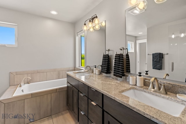 3139 Blackbird Dr, Bozeman, MT 59718 - bathroom featuring double vanity, plenty of natural light, a bath, and recessed lighting