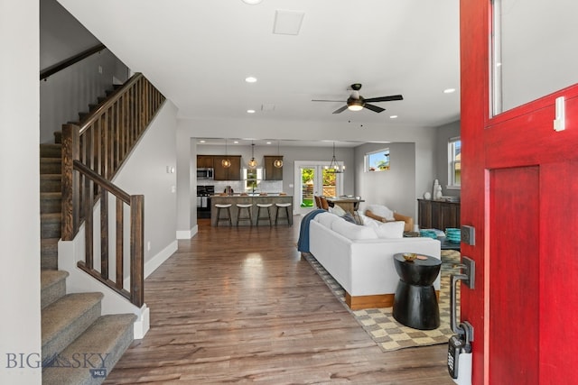 3139 Blackbird Dr, Bozeman, MT 59718 - living area with wood finished floors, a ceiling fan, stairway, and recessed lighting