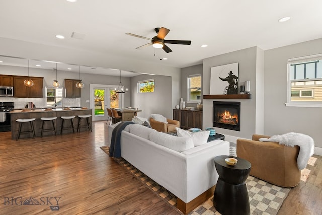 3139 Blackbird Dr, Bozeman, MT 59718 - living room with dark wood-style flooring, recessed lighting, a glass covered fireplace, and ceiling fan