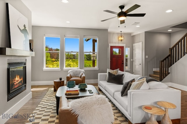 3139 Blackbird Dr, Bozeman, MT 59718 - living room featuring recessed lighting, stairway, light wood-type flooring, a large fireplace, and a ceiling fan