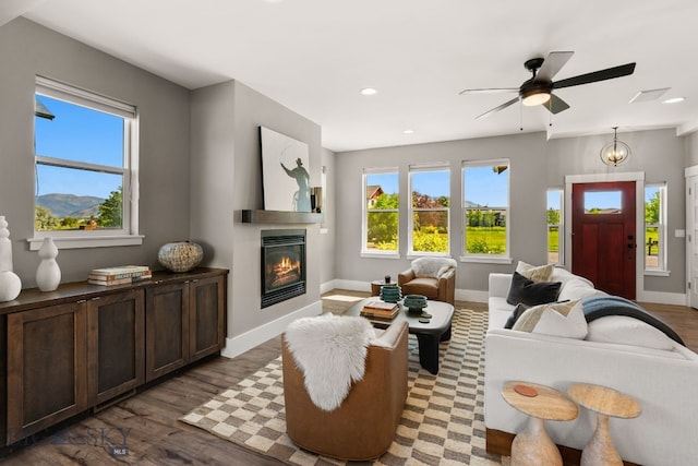 3139 Blackbird Dr, Bozeman, MT 59718 - living room featuring healthy amount of natural light, a glass covered fireplace, wood finished floors, ceiling fan, and recessed lighting