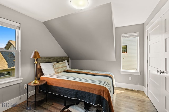 3139 Blackbird Dr, Bozeman, MT 59718 - bedroom with wood finished floors and vaulted ceiling