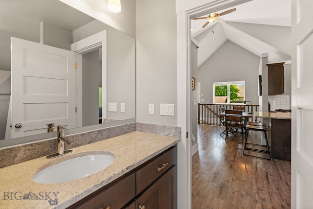 3139 Blackbird Dr, Bozeman, MT 59718 - bathroom with wood finished floors, ceiling fan, vanity, lofted ceiling, and backsplash