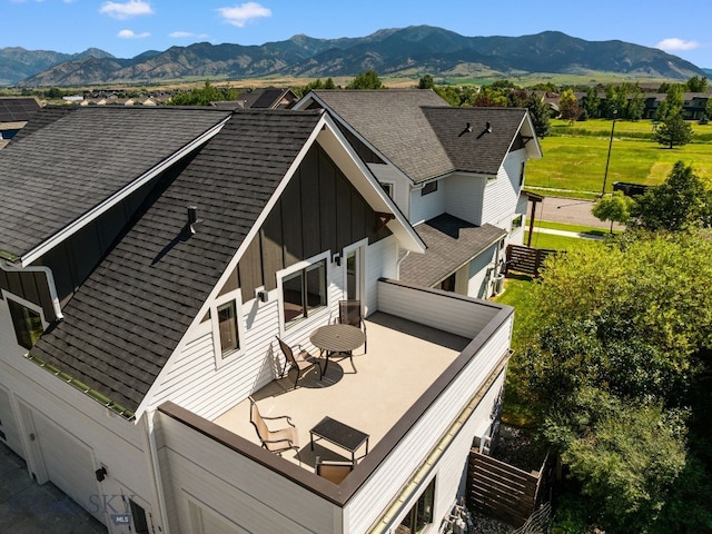 3139 Blackbird Dr, Bozeman, MT 59718 - rear view of house featuring board and batten siding, a mountain view, and a shingled roof