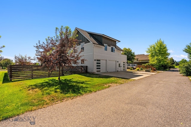 3139 Blackbird Dr, Bozeman, MT 59718 - view of home's exterior with board and batten siding, an attached garage, and concrete driveway