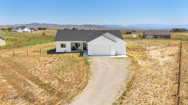 15 Santa Fe Trl, Three Forks, MT 59752 - view of front of property with driveway, a garage, and a mountain view