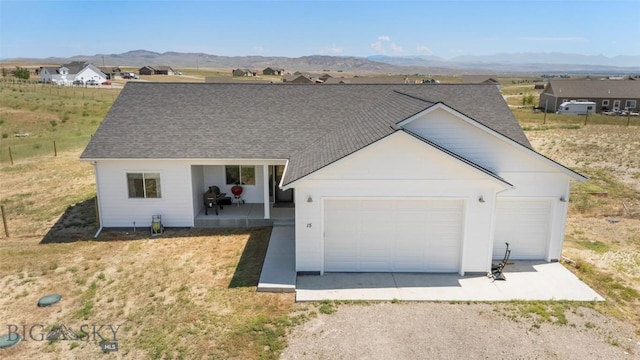 15 Santa Fe Trl, Three Forks, MT 59752 - view of front of house featuring a mountain view, driveway, and a shingled roof