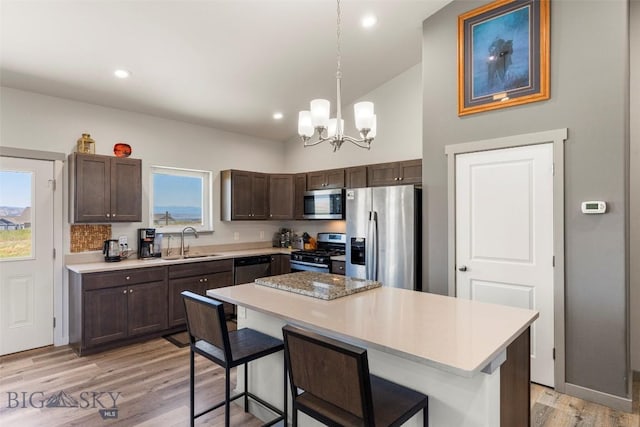 15 Santa Fe Trl, Three Forks, MT 59752 - kitchen with stainless steel appliances, dark brown cabinetry, a chandelier, light countertops, and recessed lighting