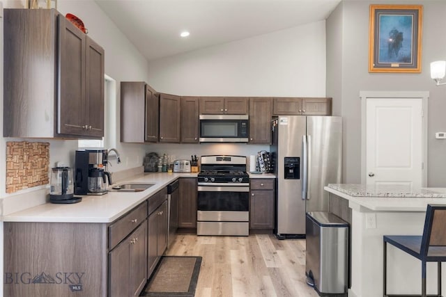 15 Santa Fe Trl, Three Forks, MT 59752 - kitchen featuring appliances with stainless steel finishes, light countertops, light wood-style flooring, a breakfast bar area, and recessed lighting