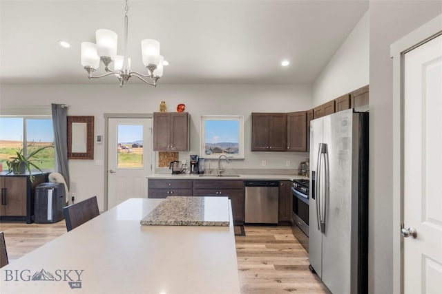 15 Santa Fe Trl, Three Forks, MT 59752 - kitchen featuring stainless steel appliances, light countertops, light wood finished floors, decorative light fixtures, and a chandelier