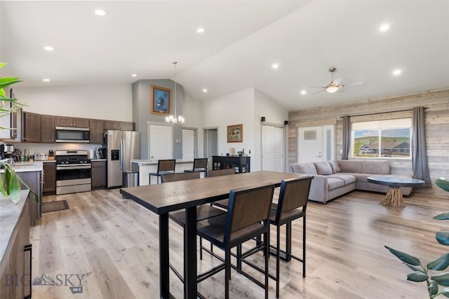 15 Santa Fe Trl, Three Forks, MT 59752 - dining room featuring high vaulted ceiling, a barn door, light wood finished floors, ceiling fan, and a chandelier