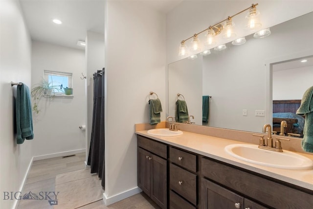15 Santa Fe Trl, Three Forks, MT 59752 - ensuite bathroom featuring double vanity, recessed lighting, and tile patterned floors
