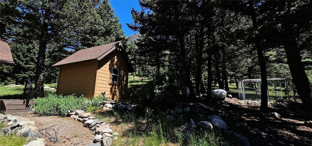 1105 S Boulder Rd, Cardwell, MT 59721 - view of property exterior featuring a storage unit and a shingled roof