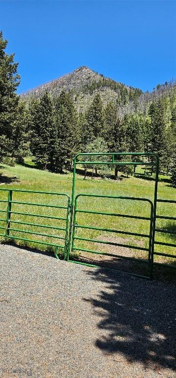 1105 S Boulder Rd, Cardwell, MT 59721 - gate featuring a view of countryside, a view of trees, and a mountain view