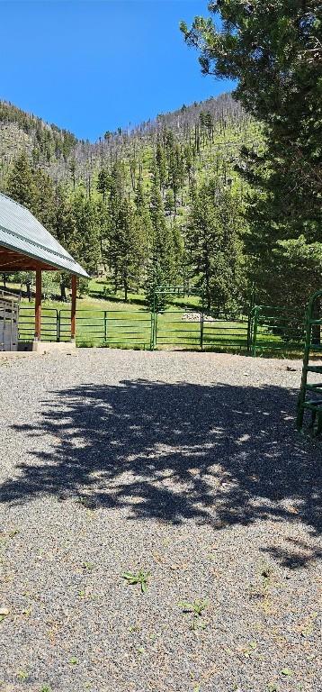 1105 S Boulder Rd, Cardwell, MT 59721 - view of dirt / gravel driveway featuring a wooded view