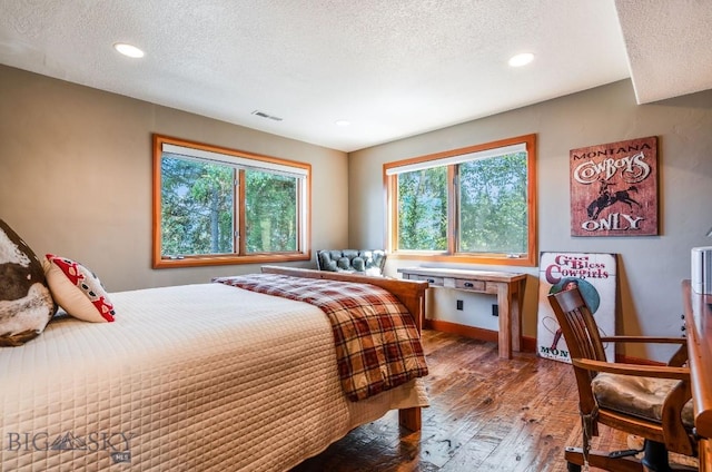 953 Angel Point Rd, Lakeside, MT 59922 - bedroom featuring a textured ceiling, hardwood / wood-style flooring, and recessed lighting