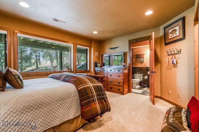953 Angel Point Rd, Lakeside, MT 59922 - carpeted bedroom with recessed lighting, a textured ceiling, and connected bathroom