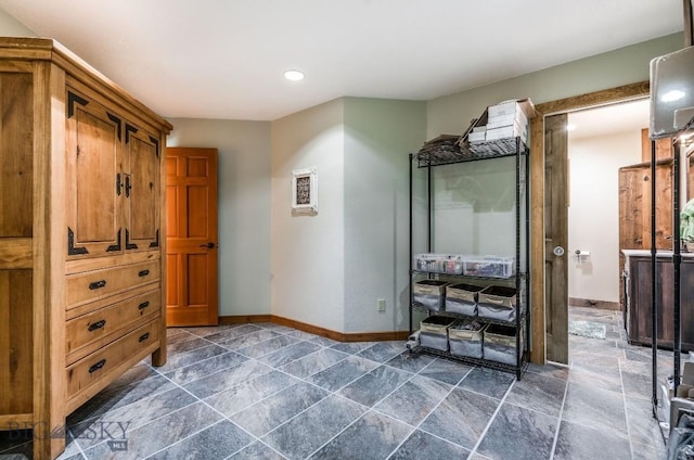 953 Angel Point Rd, Lakeside, MT 59922 - bedroom featuring dark stone finish flooring and recessed lighting