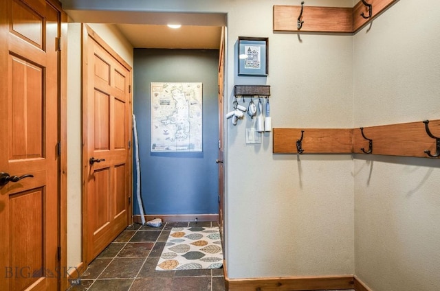 953 Angel Point Rd, Lakeside, MT 59922 - doorway to outside with baseboards and dark stone finish flooring