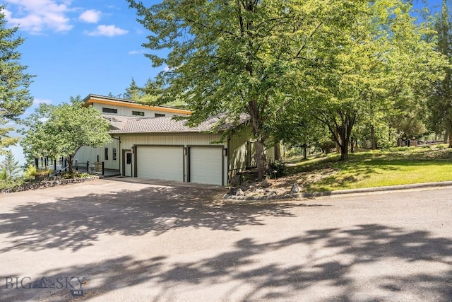 953 Angel Point Rd, Lakeside, MT 59922 - view of front facade with driveway and an attached garage