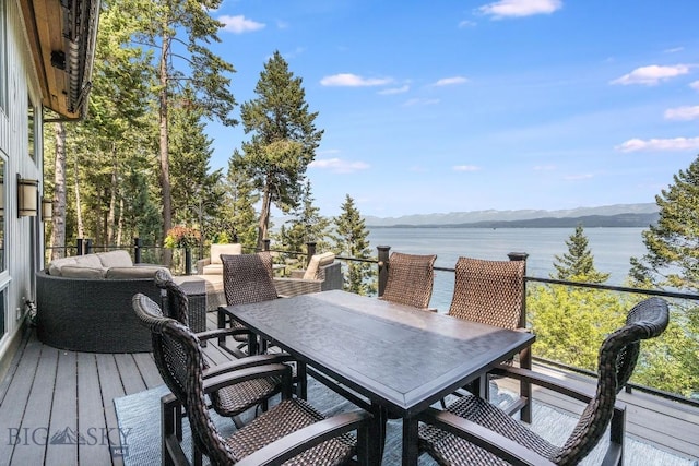 953 Angel Point Rd, Lakeside, MT 59922 - deck with a water and mountain view, an outdoor living space, and outdoor dining area