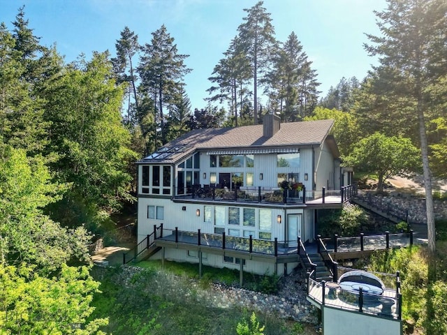 953 Angel Point Rd, Lakeside, MT 59922 - rear view of property featuring stairway, a deck, and a chimney